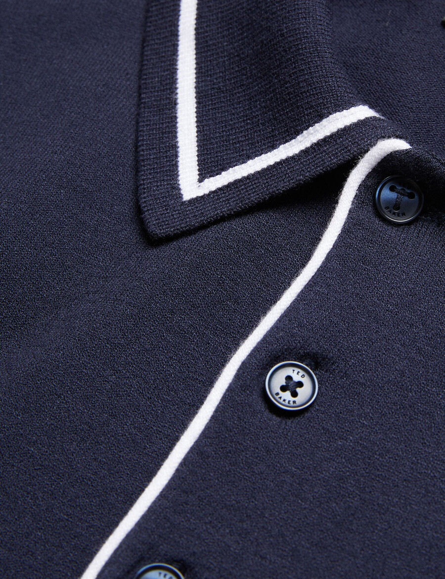 dunow - polo con ribete de rayas y detalle de pointelle